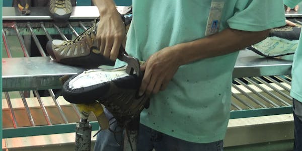 Oboz Footwear employee working on a shoe last for Sawtooth hiking boot.