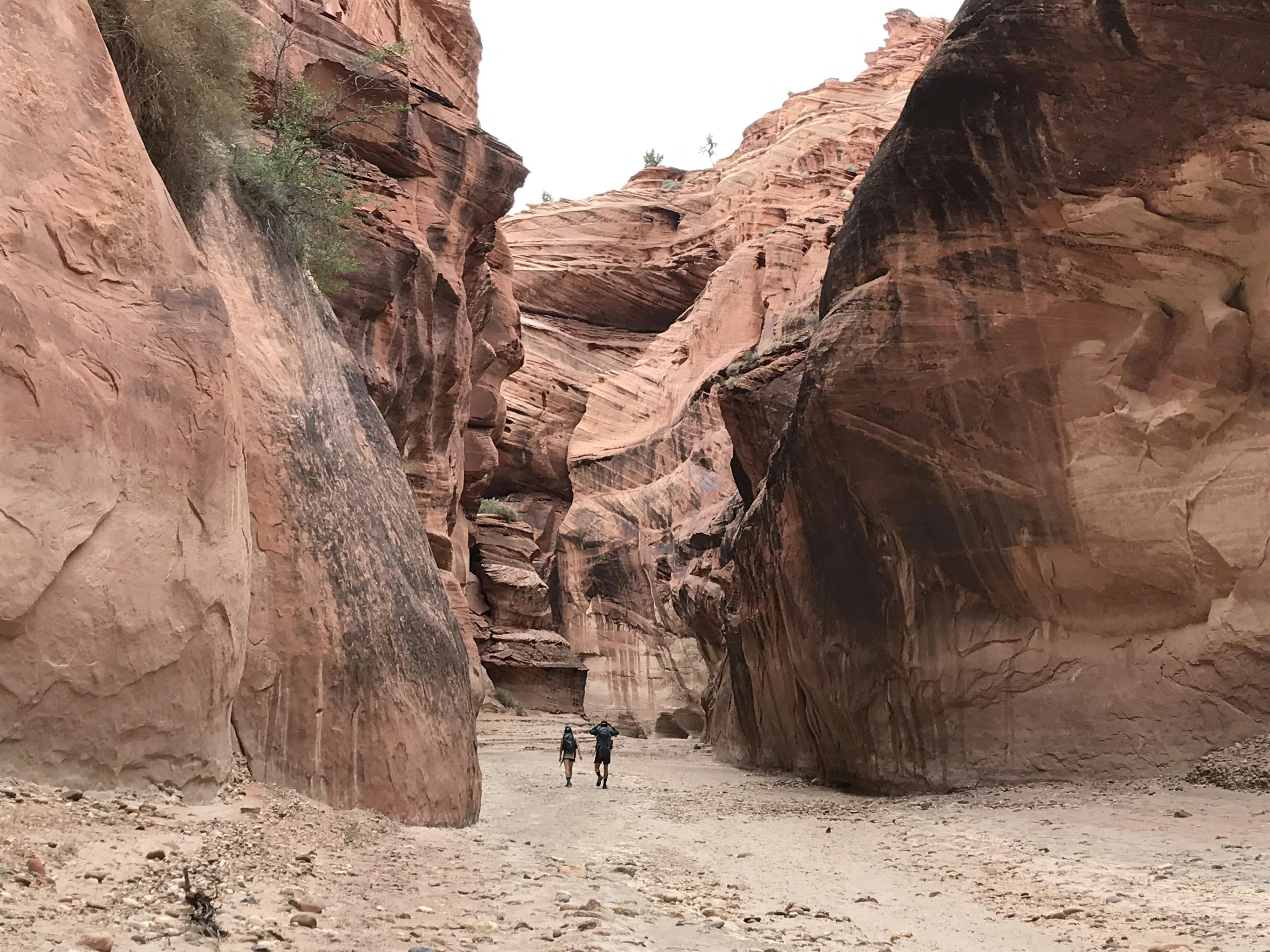 Hiking through a canyon in the desert.