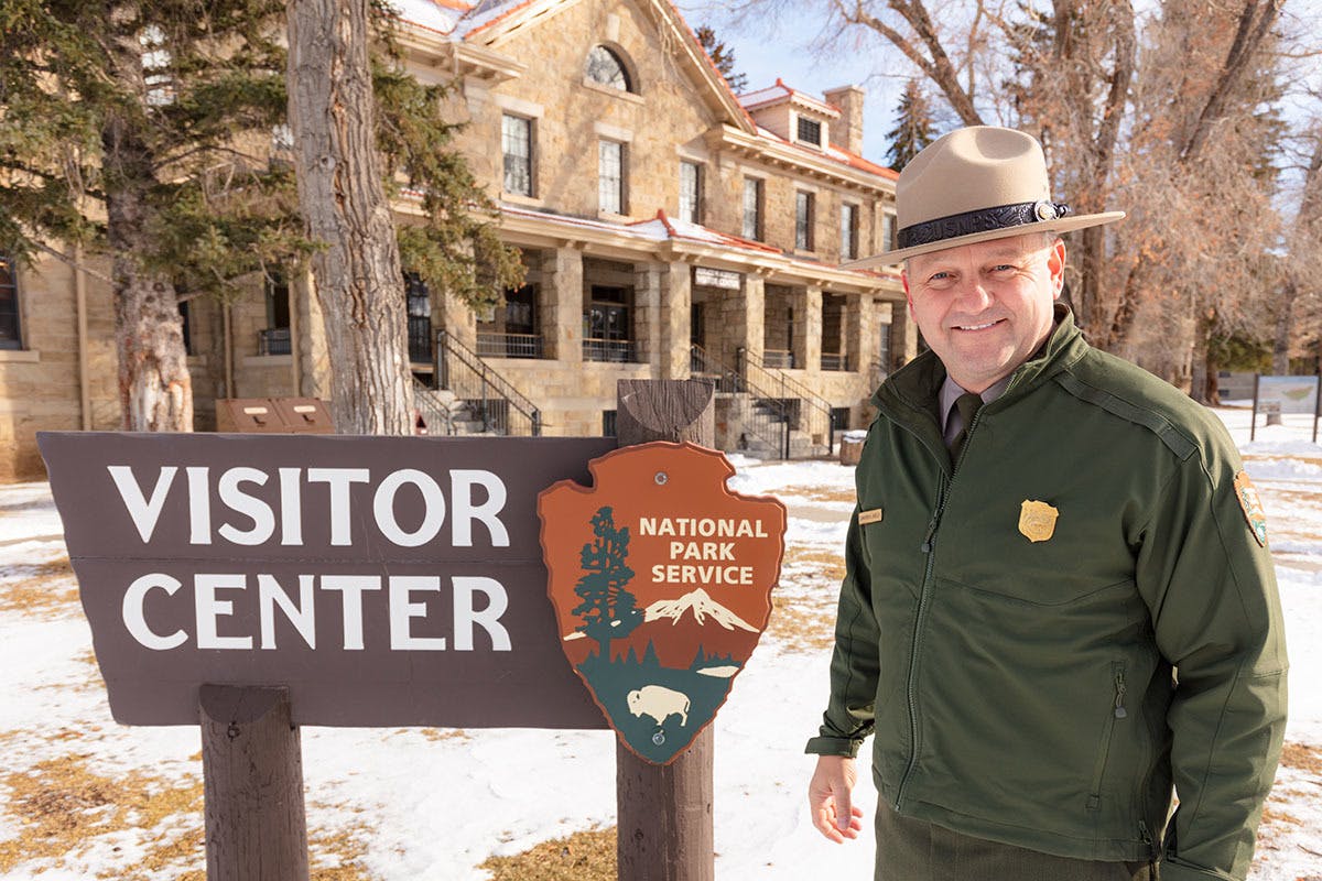 Cam Sholly posing at the Yellowstone National Park visitor center for his Oboz podcast feature.