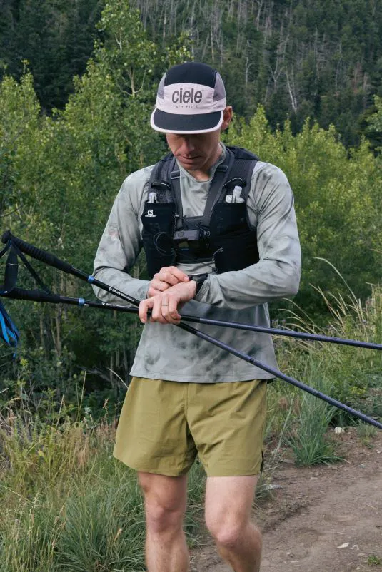 Otto Stefan checks his watch on a trail run through Montana trails.