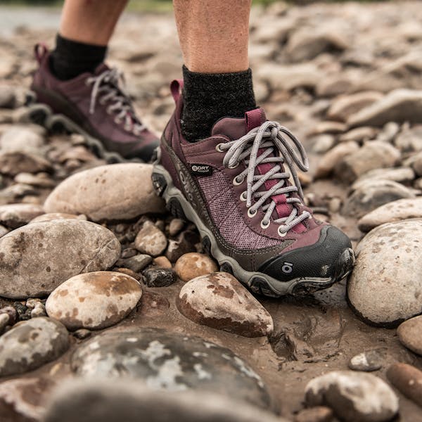 Walking on river rocks in the Women's Oboz Firebrand II Low hiking shoes.