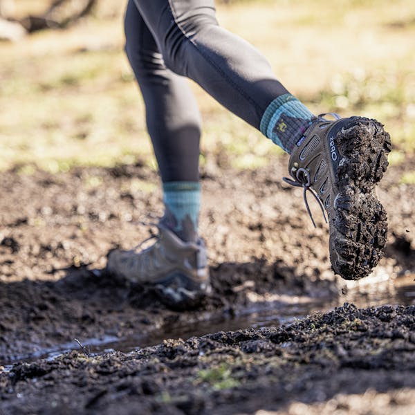 Hiking through the mud in the Oboz Women's Sawtooth II Mid Waterproof.