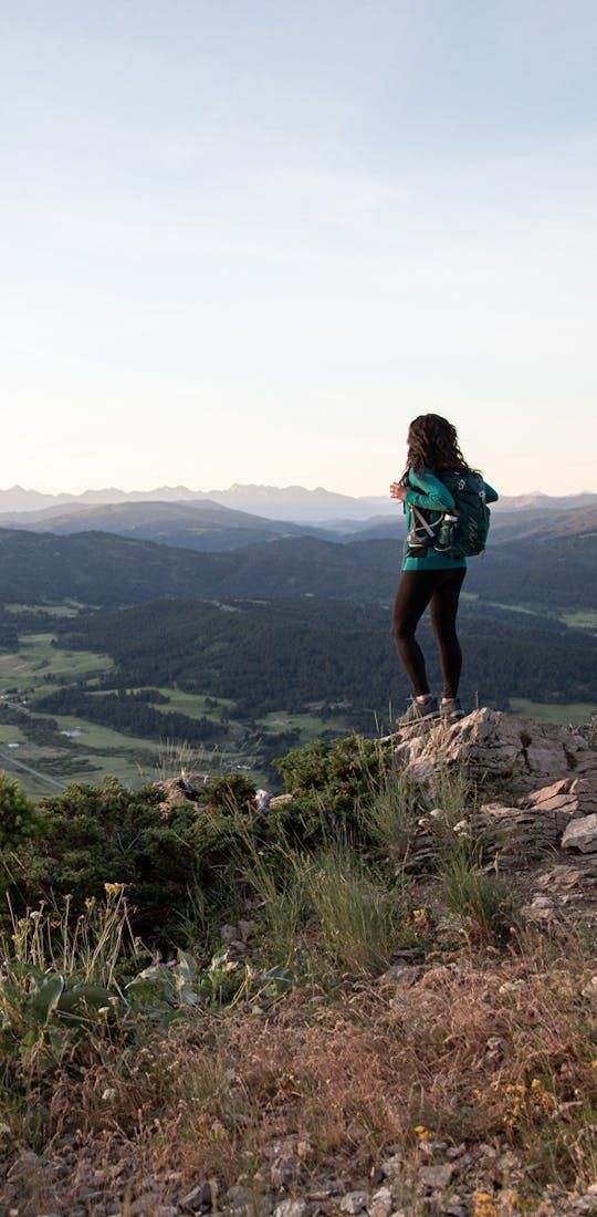 Jackie Nourse overlooking mountain ranges in Oboz hiking boots.