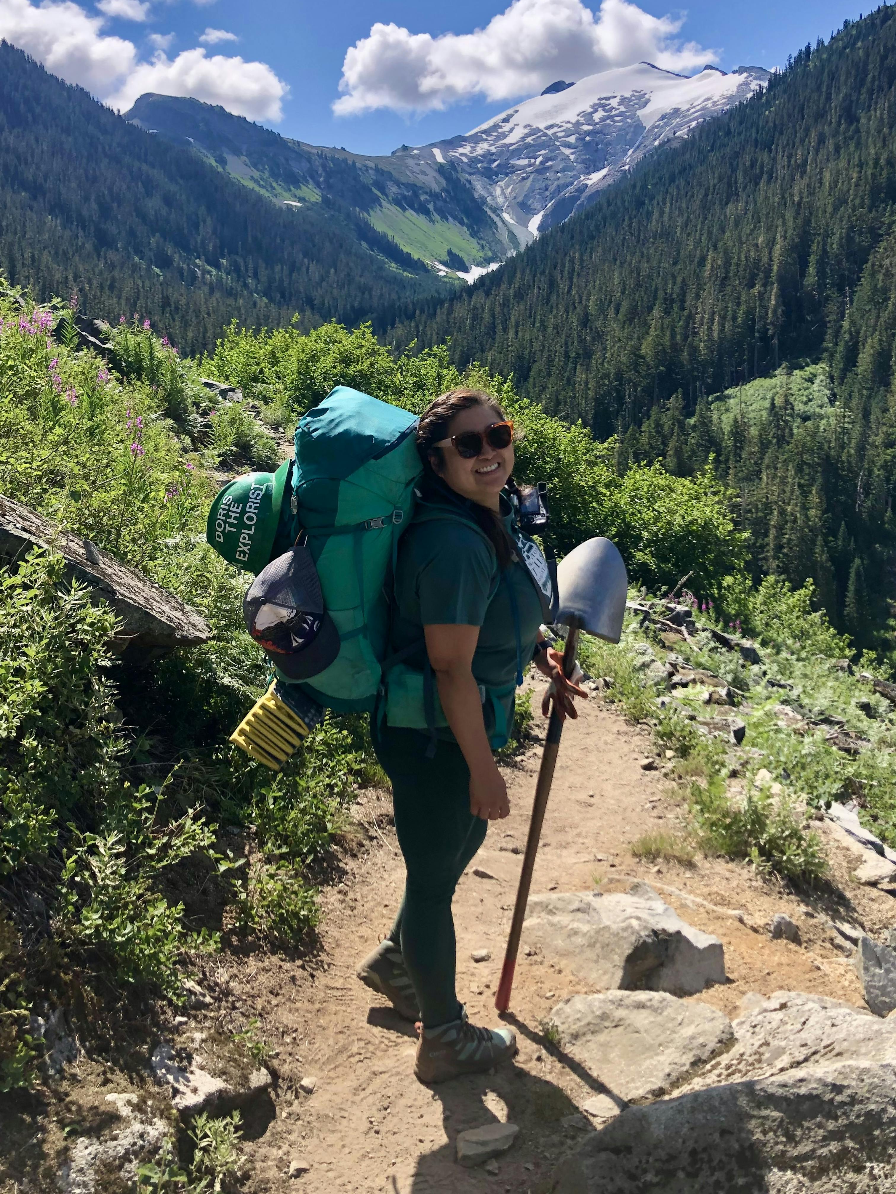 Doris on Hannegan Pass Trail with a shovel for trail work.