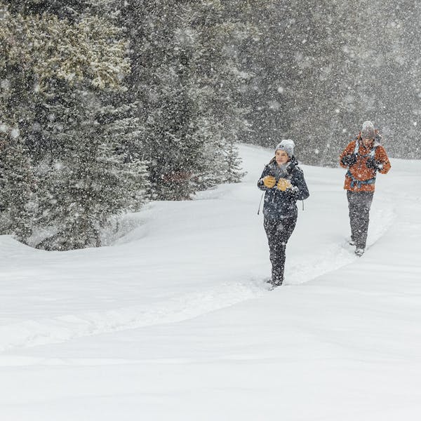 Two people snow shoeing in Oboz winter boots.