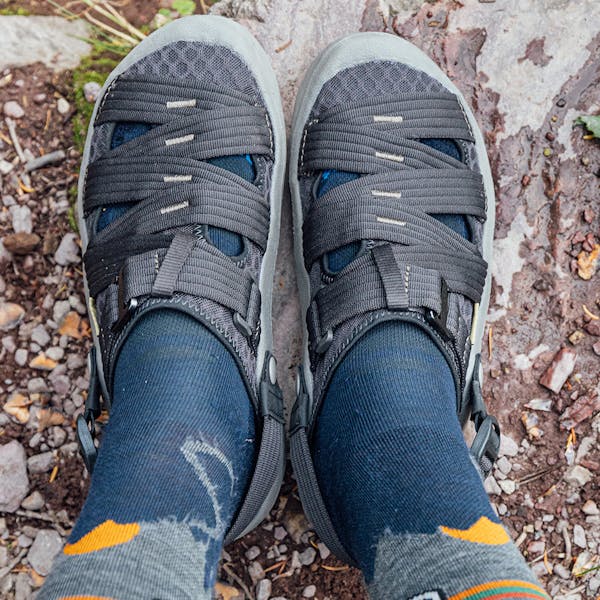 Oboz Whakatā Trail camp sandal on foot with socks.