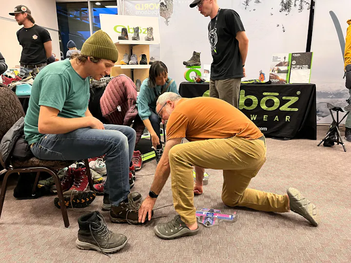 Oboz employees fitting customers for hiking boots.
