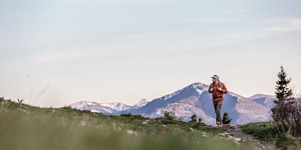 Man hiking in the mountains with his Oboz Footwear.