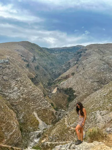 Woman hiking on the top of a mountain in the Sawtooth X Mid hiking boots