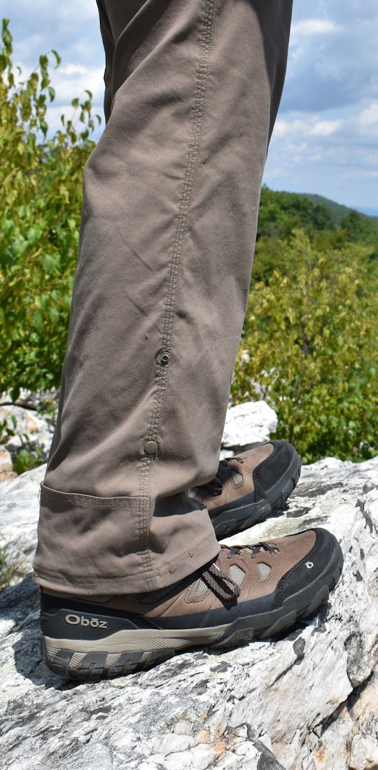 Hiker on rocky overlook wearing Oboz Sawtooth X hiking boots.