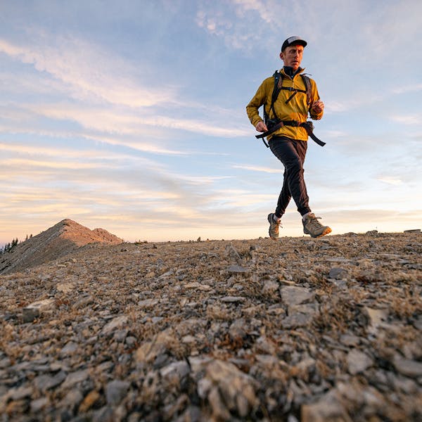 Hiker quickly moving along a ridge in the Bridger mountain range wearing the Oboz Katabatic Low hiking shoes.