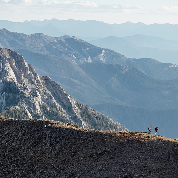 Two hikers navigating a ridgeline in the Bridger Mountains near Bozeman, MT.
