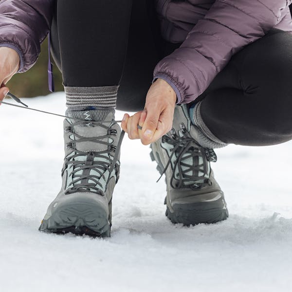 Lacing up the women's Oboz Bangtail snow boots in the snow. 