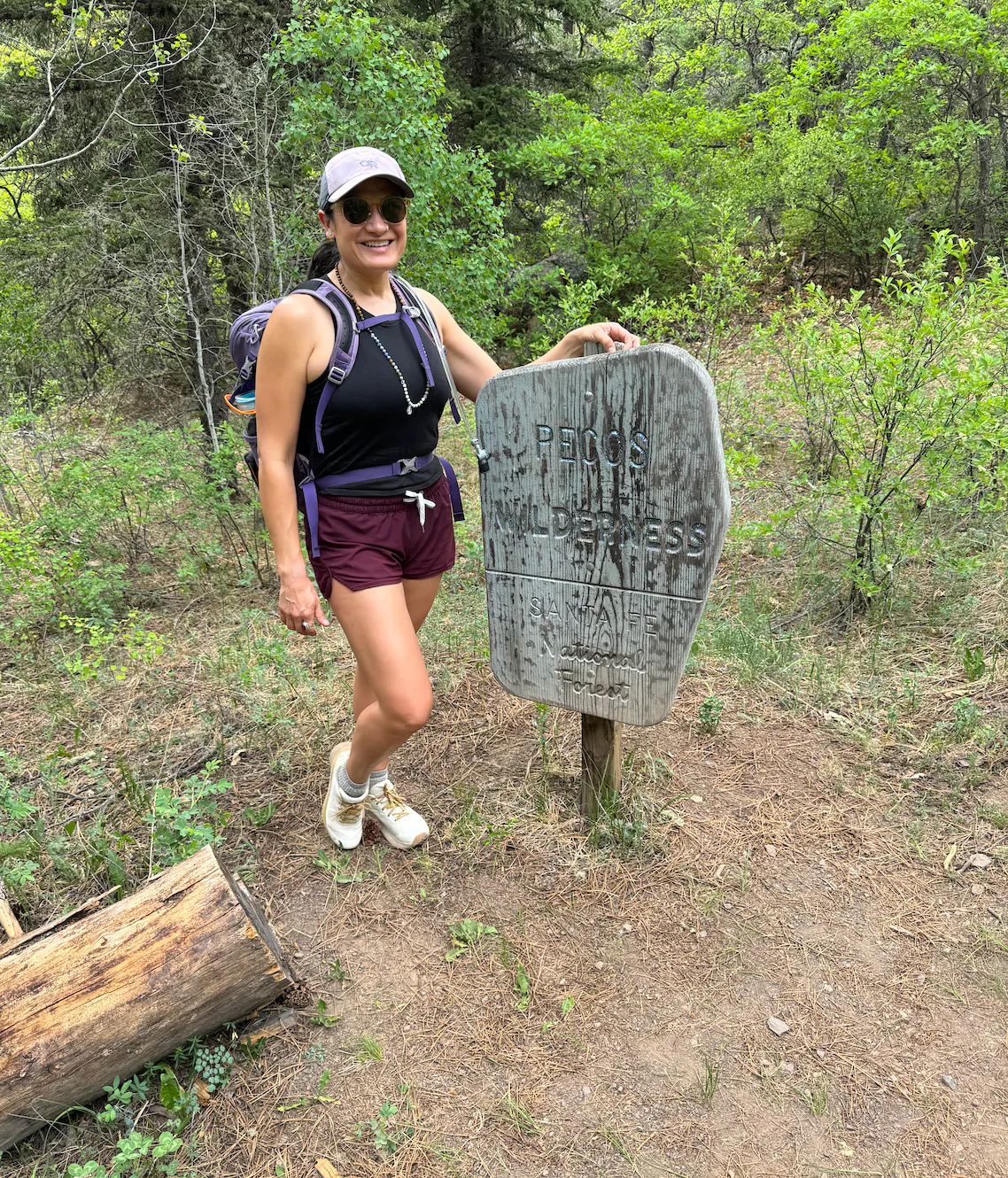 Karla Amador in her Oboz Katabatic Wind fast trail shoes at a trail sign.