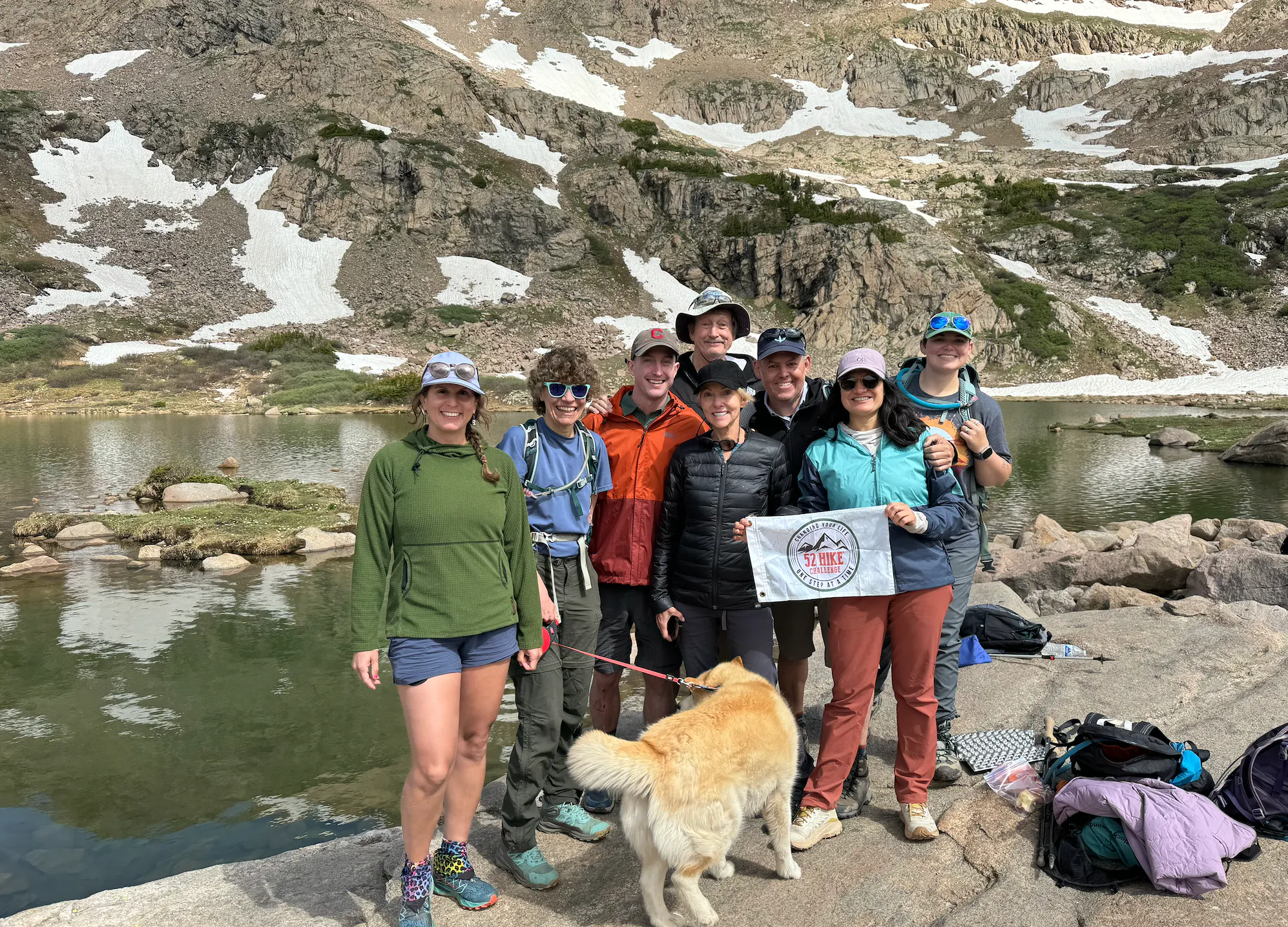 A group of 52 hikes challenge hikers at a mountain lake.