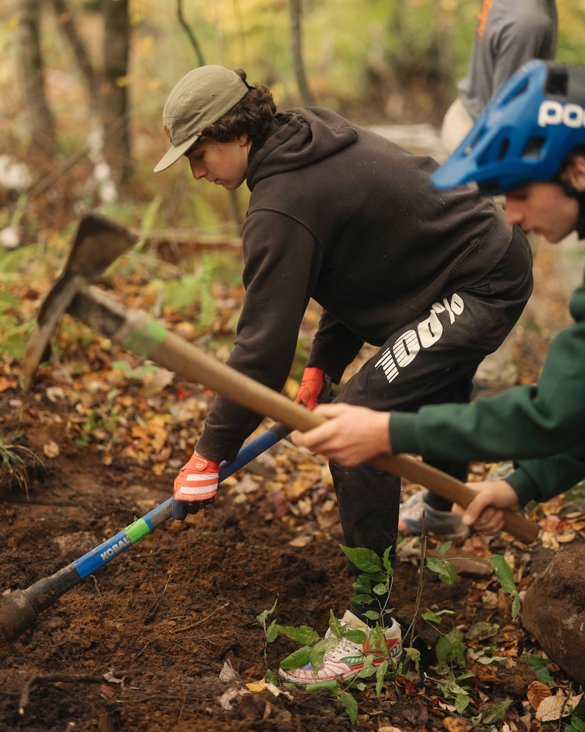 Two young trial builders help to repair trail systems.