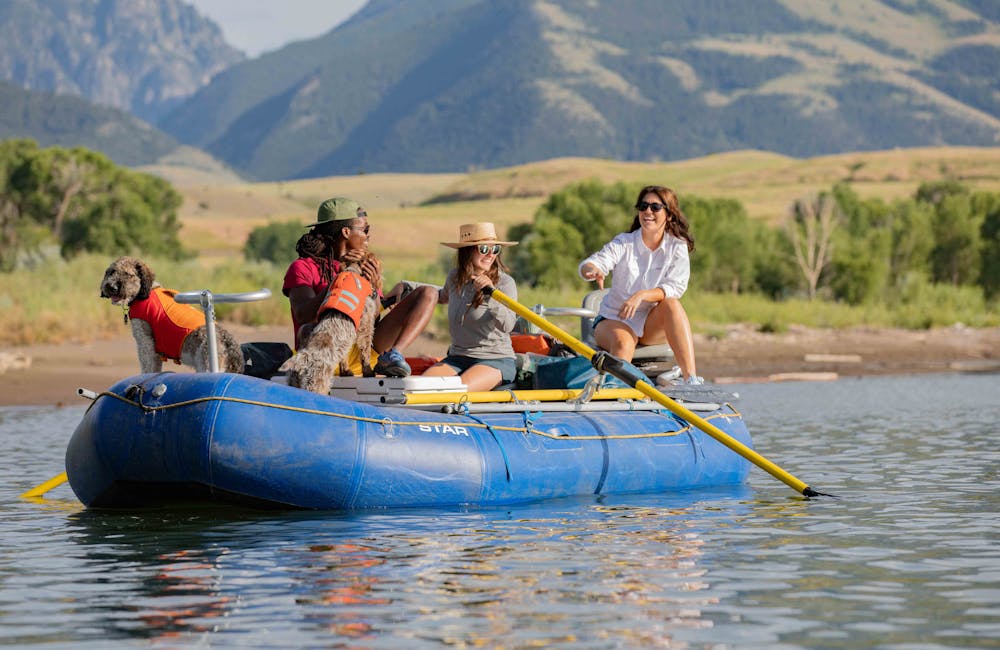 Group of people rafting down the Yellowstone River in Montana while wearing Oboz sandals.