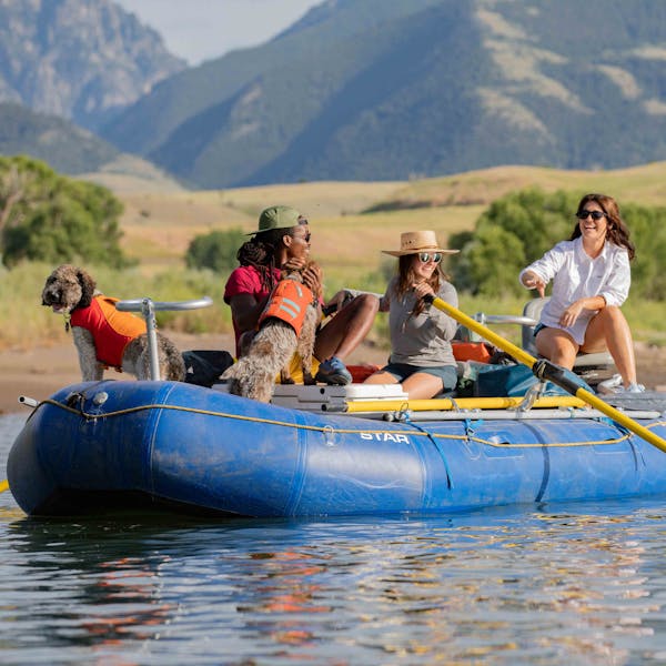 Group of people rafting down the Yellowstone River in Montana while wearing Oboz sandals.