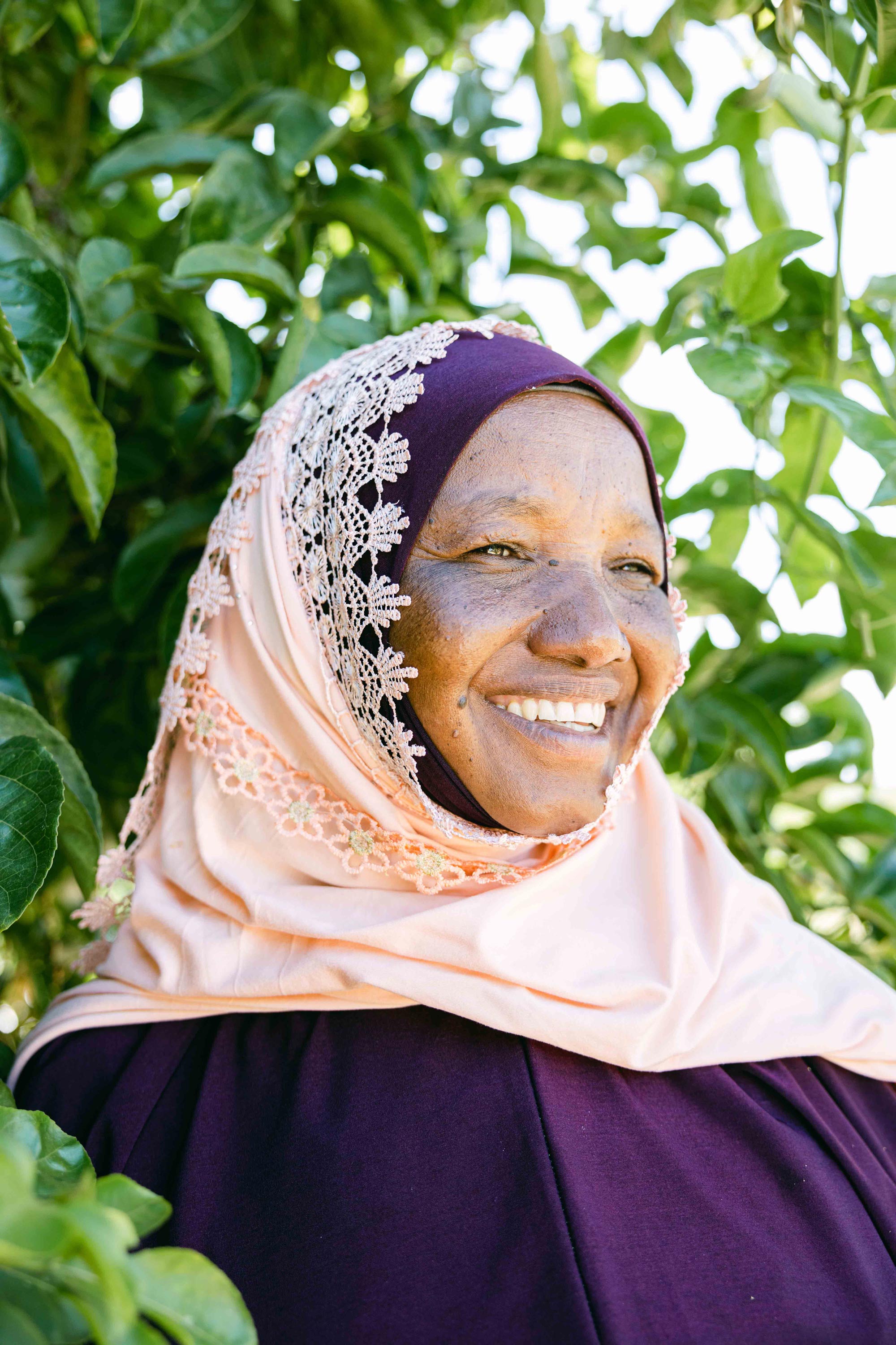 Woman smiling in a One More Tree farming facility.