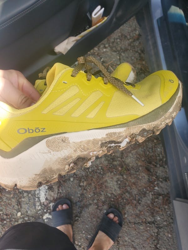 Oboz Katabatic fast trail shoe covered in mud after a long day of adventures. 