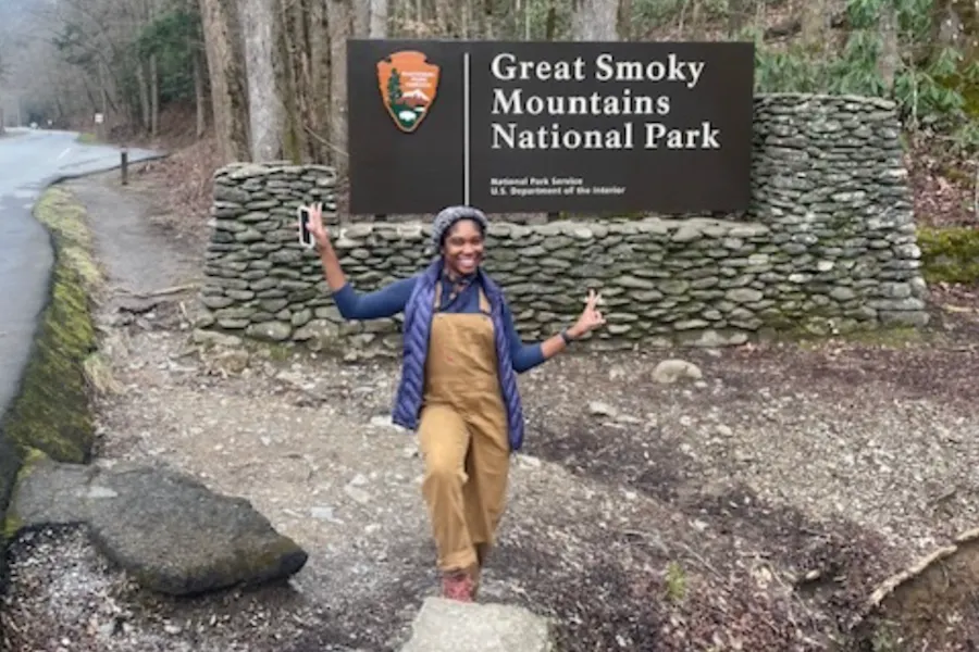 K. Walker in front of the entry sign to Great Smoky Mountains National Park