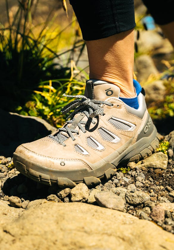 Woman hiking in Oboz Sawtooth X hiking boots through rocky trail in Patagonia.