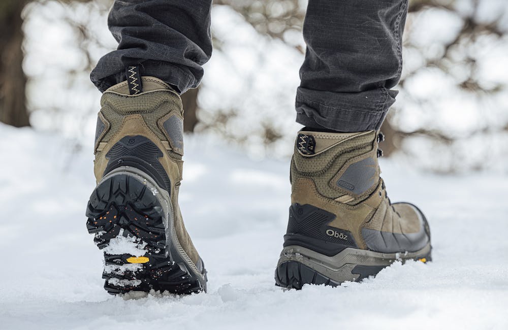Men's Oboz Bangtail insulated boot on a snowy trail.