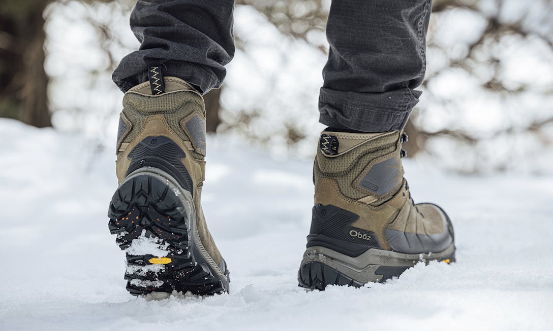 Men's Oboz Bangtail insulated boot on a snowy trail.