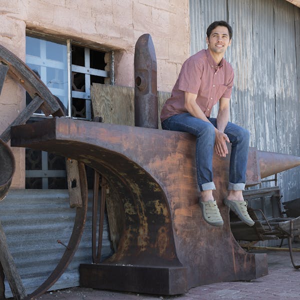 A man relaxing in the Whakata Town casual camp sandal.