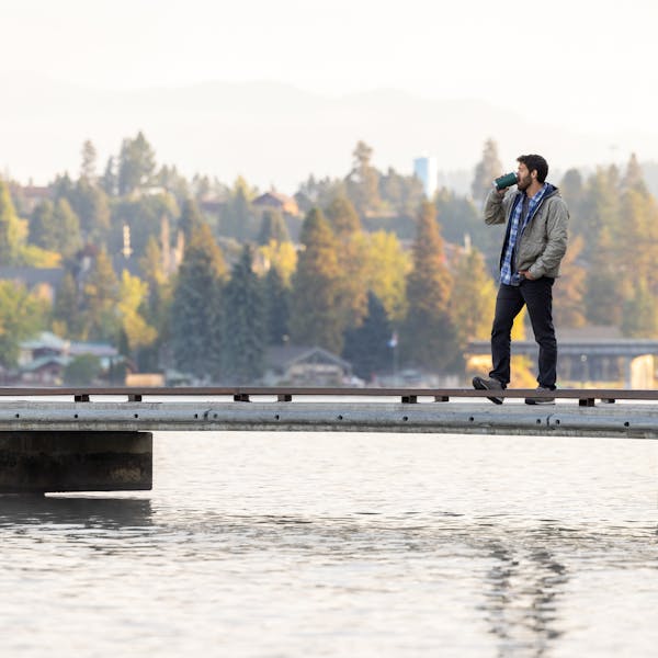A person standing on a dock in their Oboz Bozeman Low Suede.