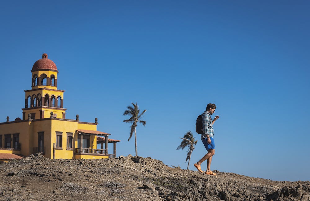 A man walking to the beach in the Whakatā Coast