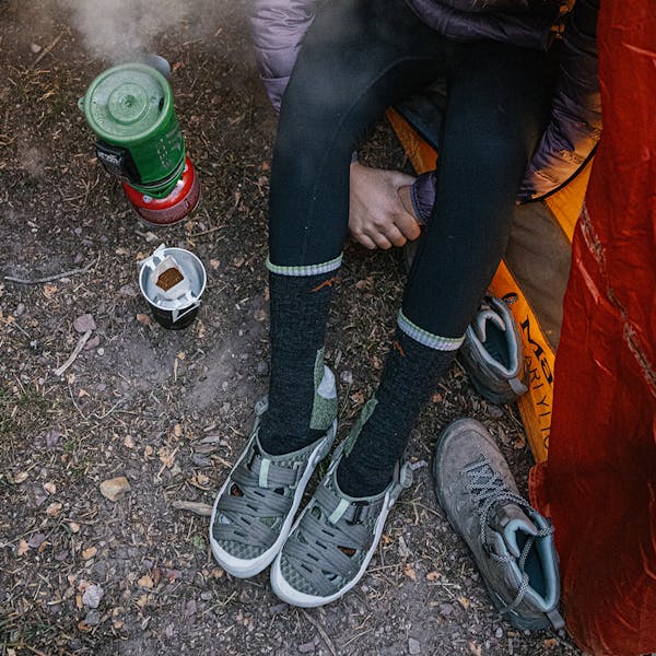 Person making coffee in the Whakatā Trail sandal.