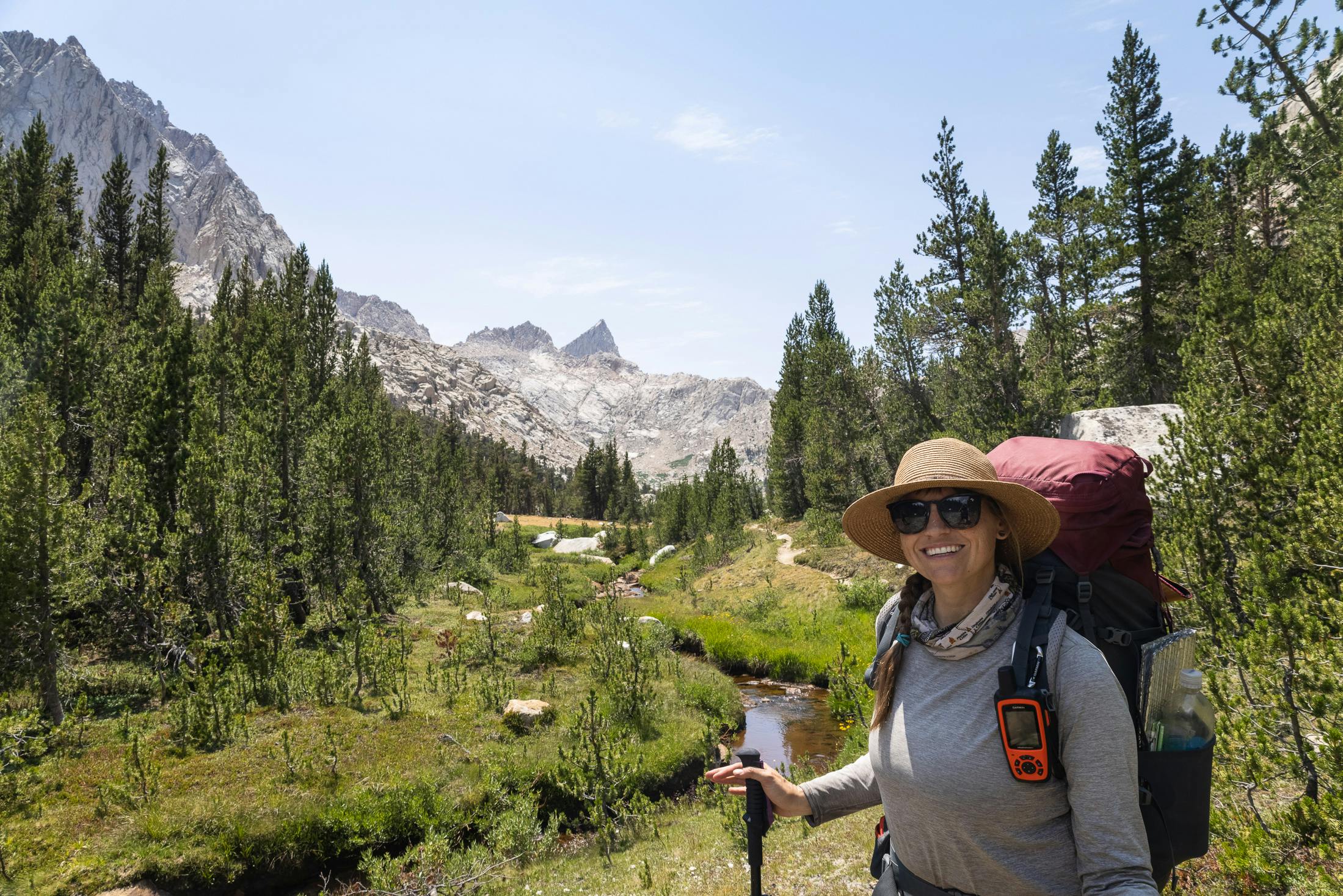 Happy hiker smiling in Sequoia National Park while on a backpacking trip.