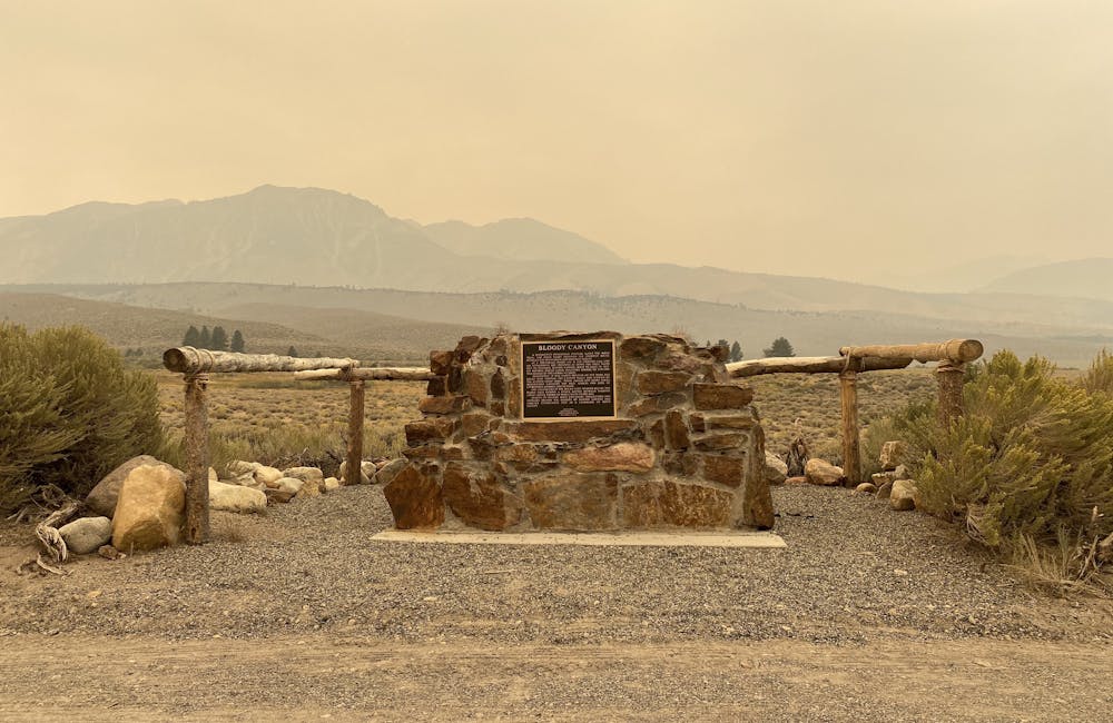 Views of an informational monument with wildfire smoke in the air.
