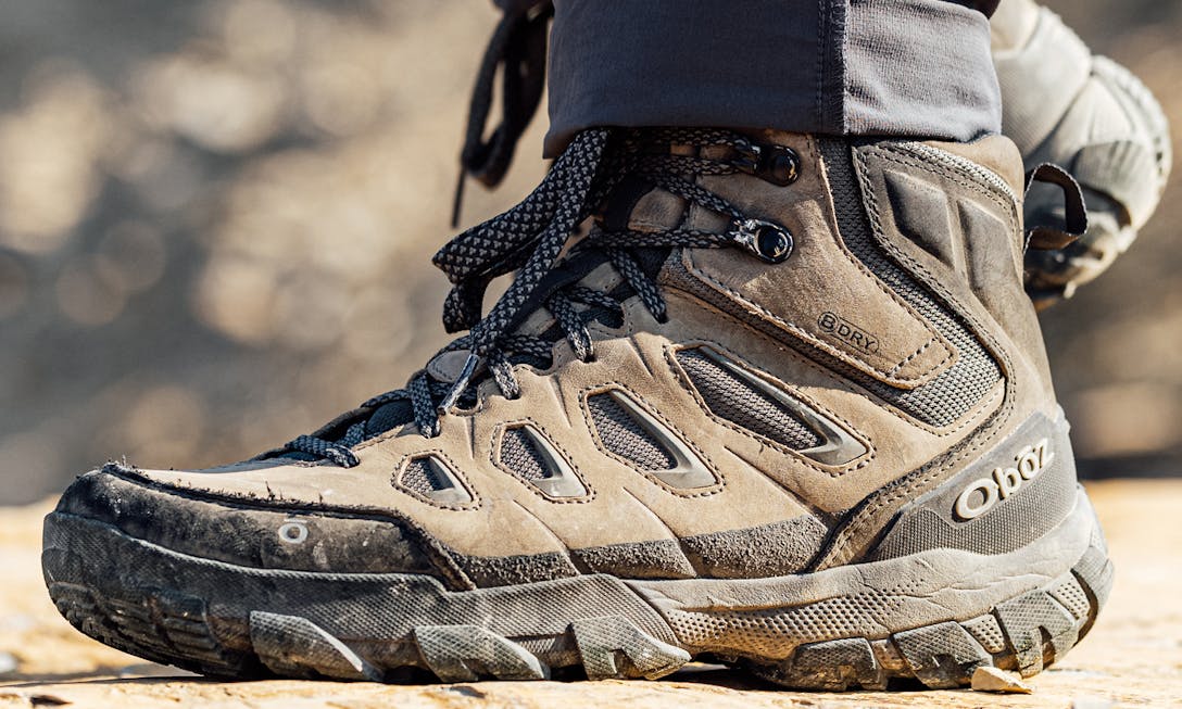 Oboz Sawtooth X hiking boot on rocky ledge while on a hike
