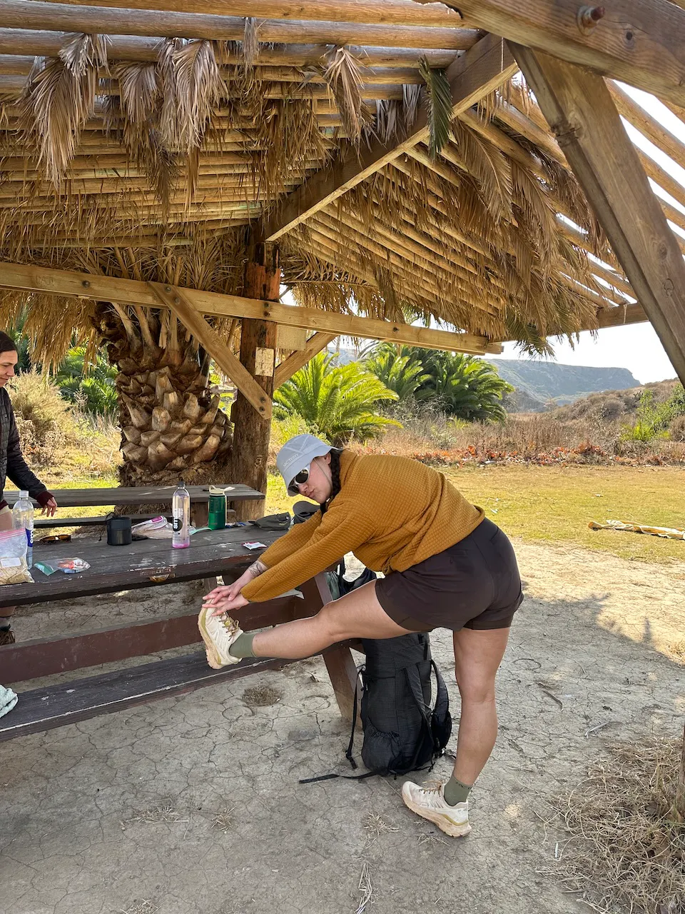 Kylie stretching in her Oboz shoes during a hike through Catalina Island