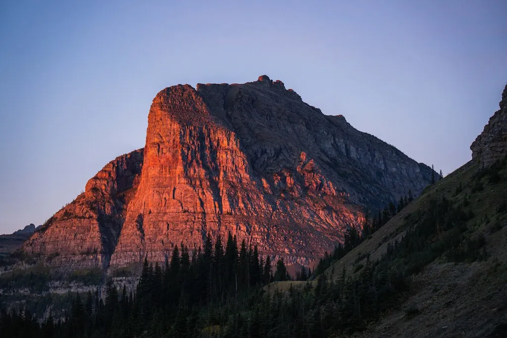 Towering rock face at sunrise in Glacier National Park