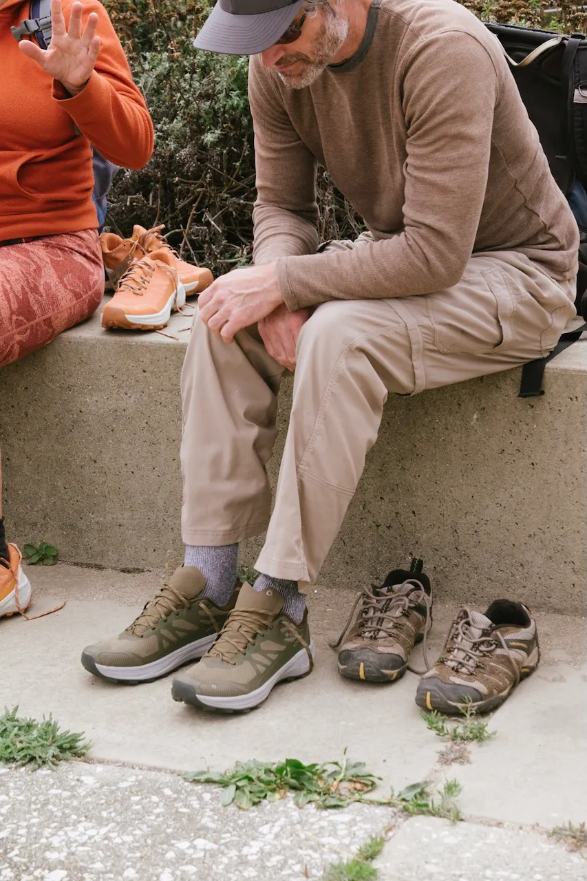 A hiker ties their Oboz Hyalite trail shoes