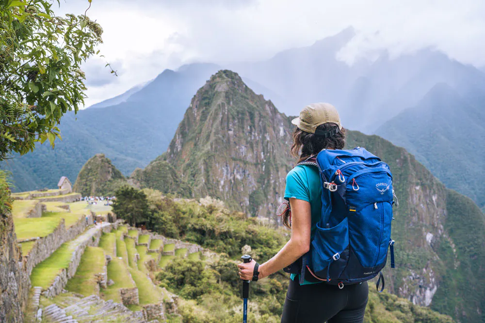 A hiker in front of expansive Peru views and rocky mountains