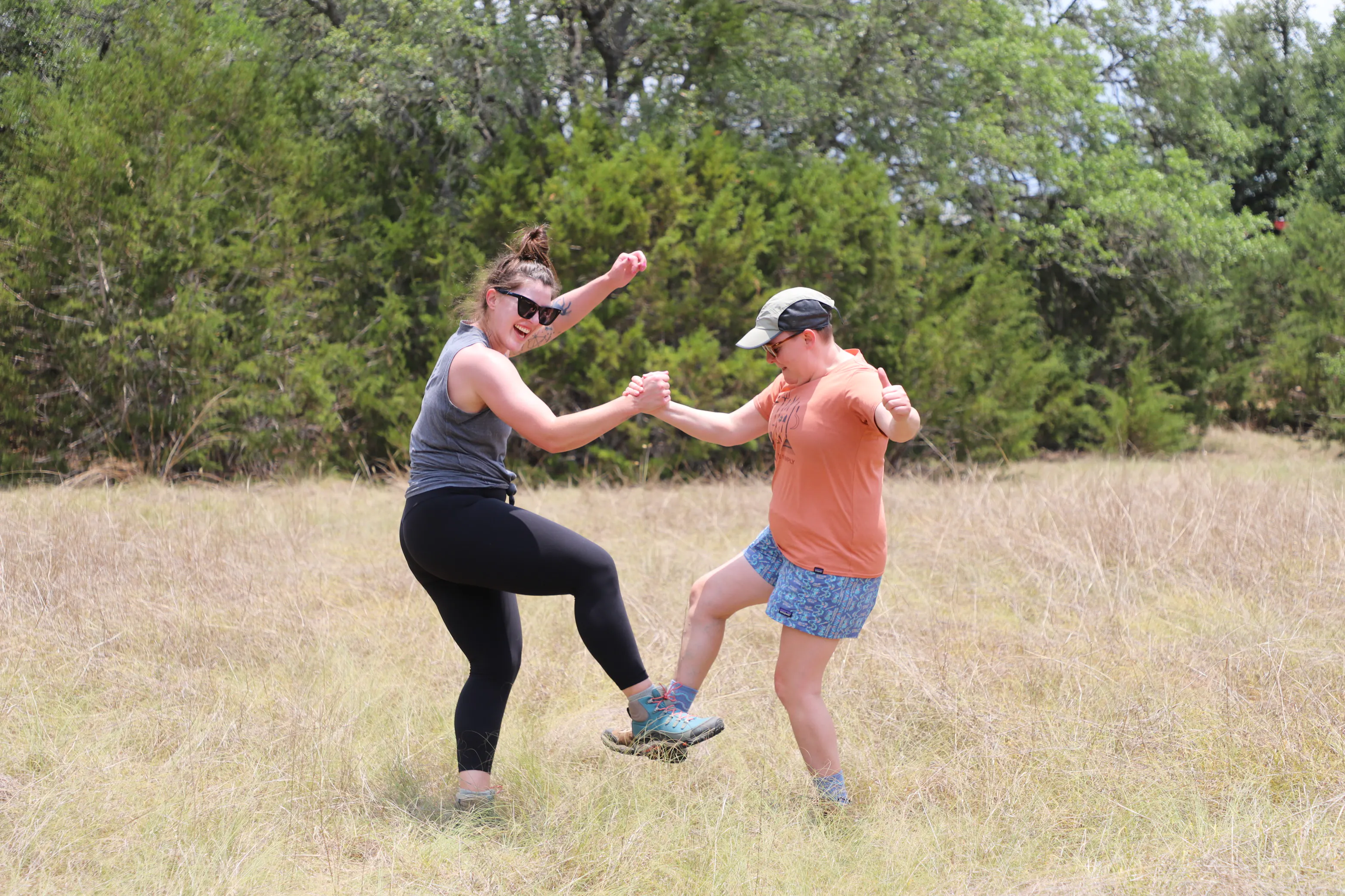 Two hikers tap feet in their Oboz hiking shoes