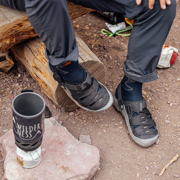 Cooking a portable stove meal in the Whakatā Trail recovery sandal.