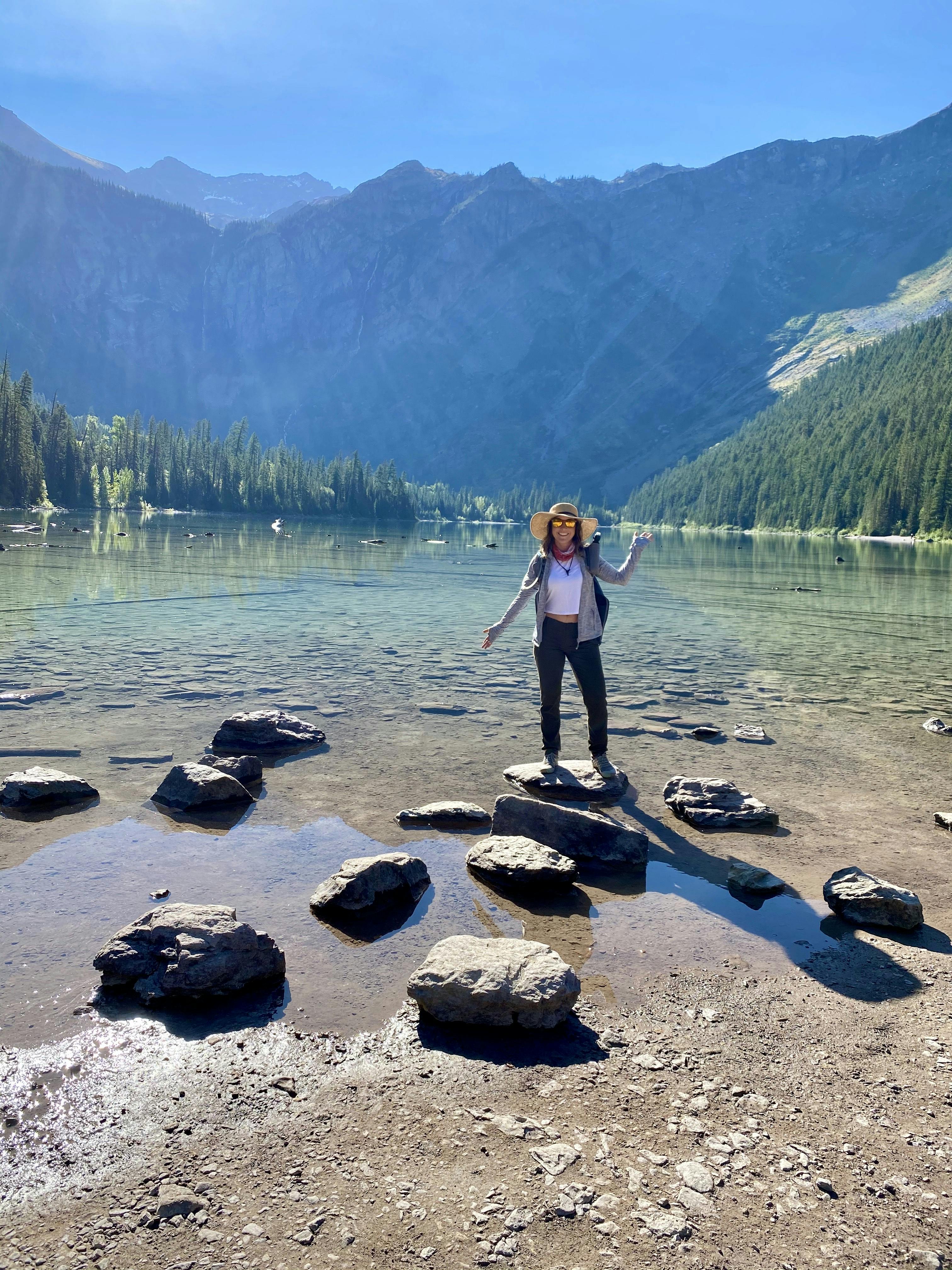 Woman hiking around in her Oboz hiking shoes around an alpine lake