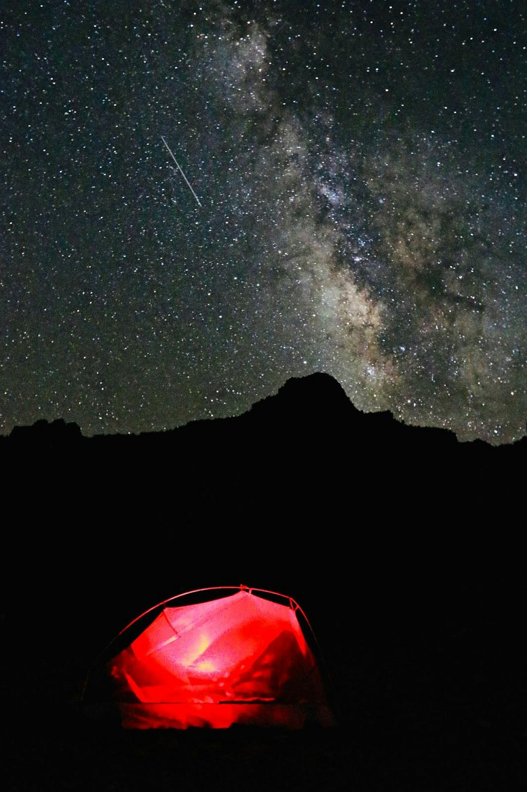 Illuminated tent with incredible view of the Milky Way above camp