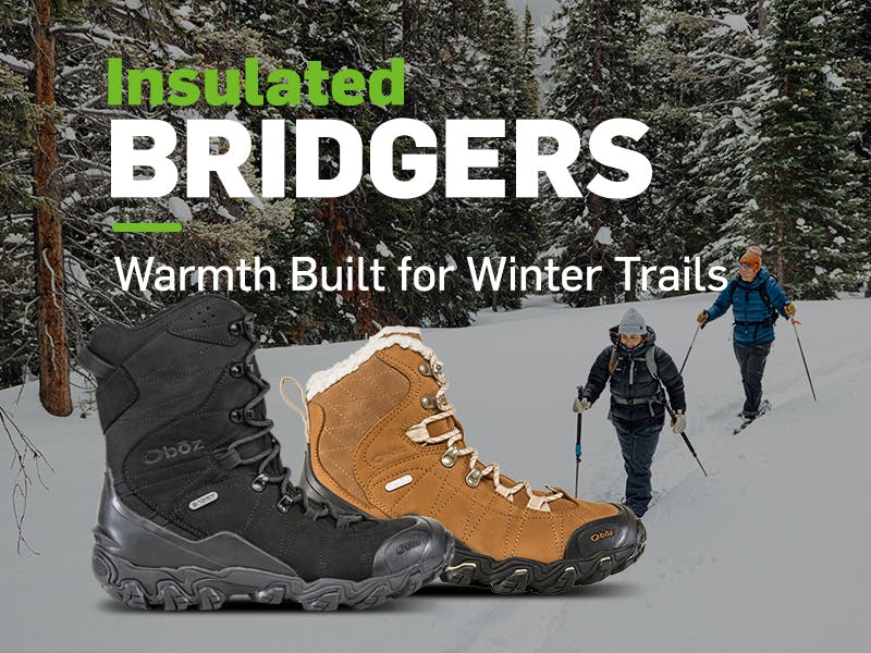Bridger Insulated styles and couple snowshoeing through a wintery pine forest.