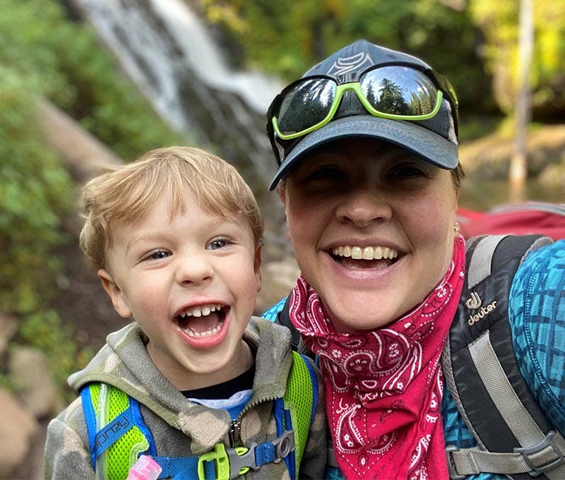 Ginny Galbreth with her son in front of a waterfall