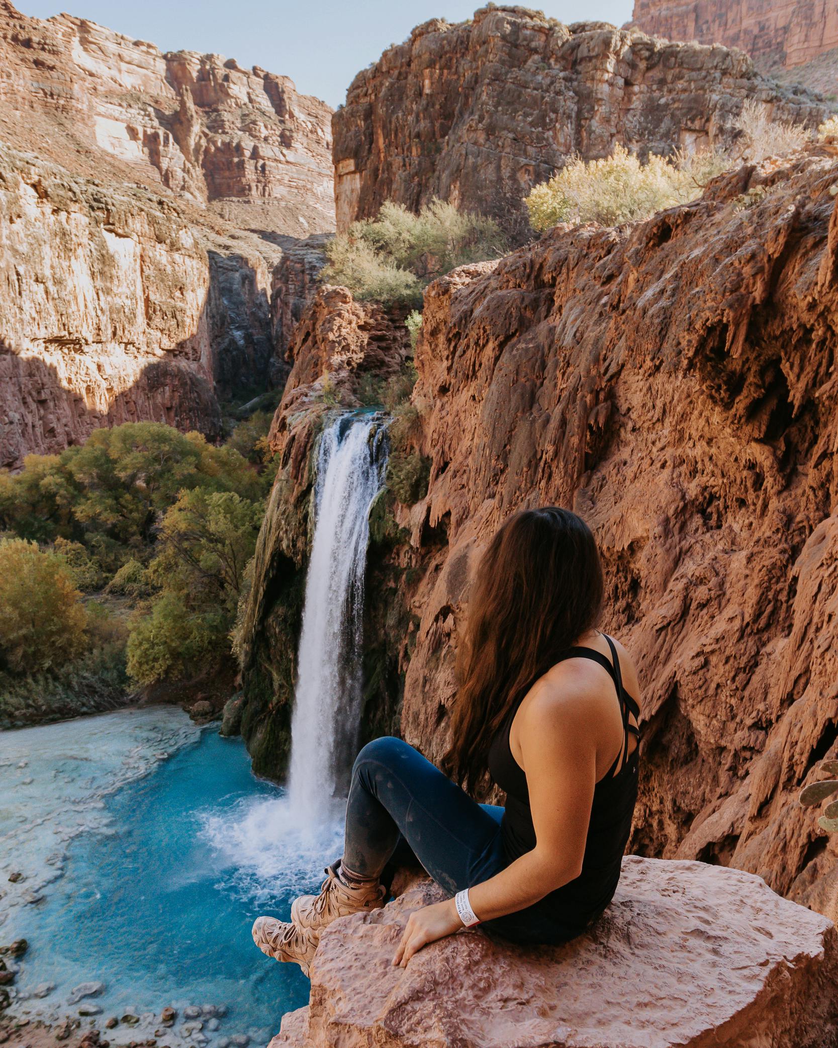 Lindsay Kagalis watching the waterfall in the Women's Sawtooth II Mid boots on Hopitutskwa, Havasu Baaja, Pueblos, and Hualapai Indigenous lands