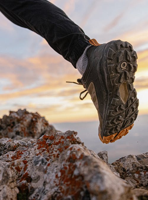 Hiker wearing Oboz Katabatic hiking shoes on a rocky mountain trail