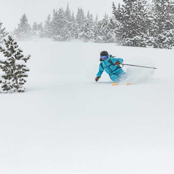 A woman skiing in the Montana backcountry with Oboz and Skida