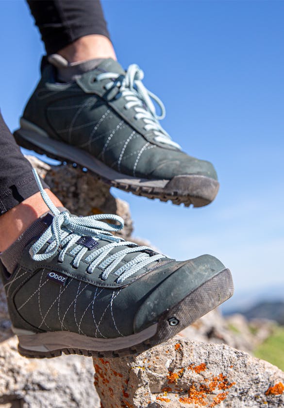 Resting on a rock with the Oboz Women's Bozeman Low Leather hiking shoe