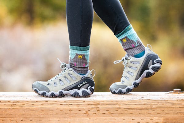 A person walking on wood planks in the sawtooth II with fun socks
